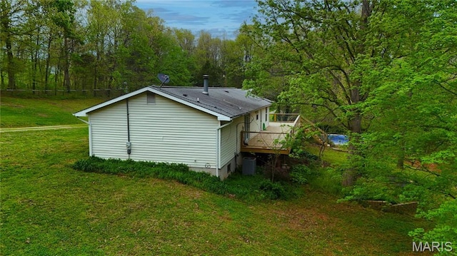 14276 State Route 21, De Soto, MO 63020 - view of property exterior with a deck, a lawn, a wooded view, and central AC unit