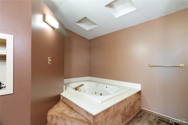 14276 State Route 21, De Soto, MO 63020 - full bathroom featuring wood finished floors, a whirlpool tub, and lofted ceiling