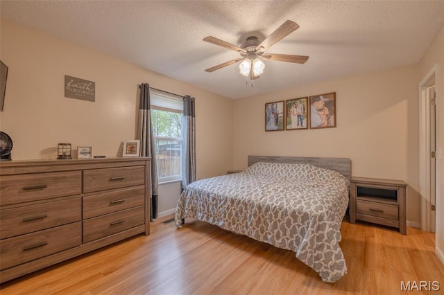 2250 Pinta Dr, Warrenton, MO 63383 - bedroom with light wood finished floors, a textured ceiling, a ceiling fan, and baseboards
