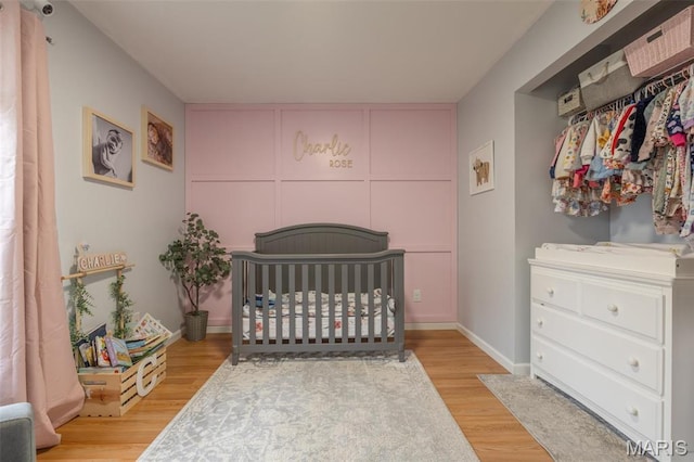 2250 Pinta Dr, Warrenton, MO 63383 - bedroom with a crib and wood finished floors