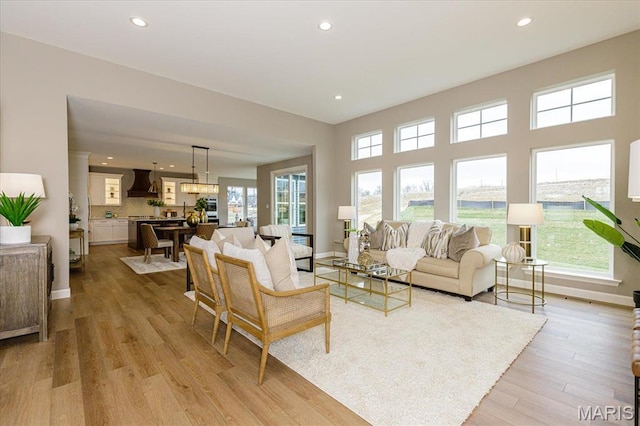 303 Clewer Park Ct, Lake St Louis, MO 63367 - living area featuring recessed lighting, light wood finished floors, and baseboards