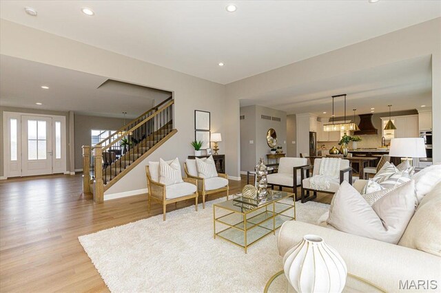 303 Clewer Park Ct, Lake St Louis, MO 63367 - living room featuring stairway, baseboards, recessed lighting, and light wood finished floors