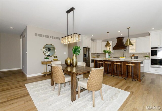 303 Clewer Park Ct, Lake St Louis, MO 63367 - dining room with light wood-type flooring, baseboards, and recessed lighting