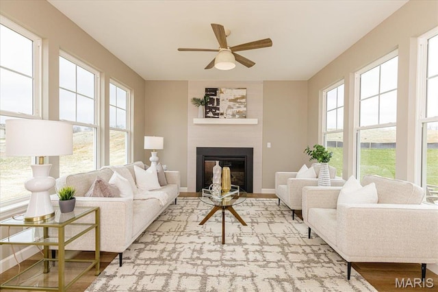 303 Clewer Park Ct, Lake St Louis, MO 63367 - living area featuring a ceiling fan, plenty of natural light, a large fireplace, and wood finished floors