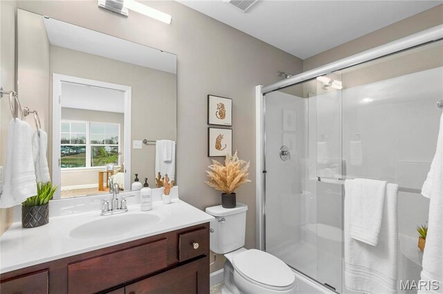 303 Clewer Park Ct, Lake St Louis, MO 63367 - bathroom featuring toilet, a shower stall, and vanity