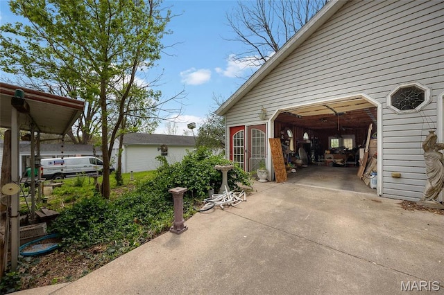 883 Biltmore St, Saint Genevieve, MO 63670 - view of property exterior featuring a garage and concrete driveway