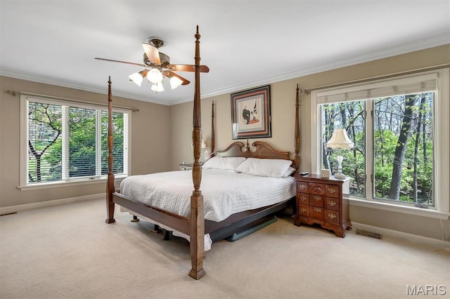 bedroom featuring baseboards, light colored carpet, crown molding, and a ceiling fan