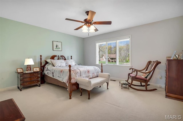 carpeted bedroom featuring baseboards and a ceiling fan