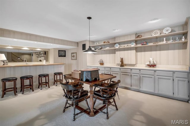 dining area featuring light colored carpet