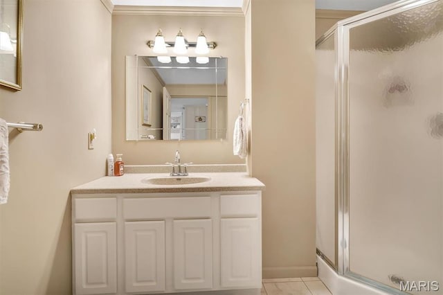 bathroom with a shower stall, vanity, and tile patterned flooring
