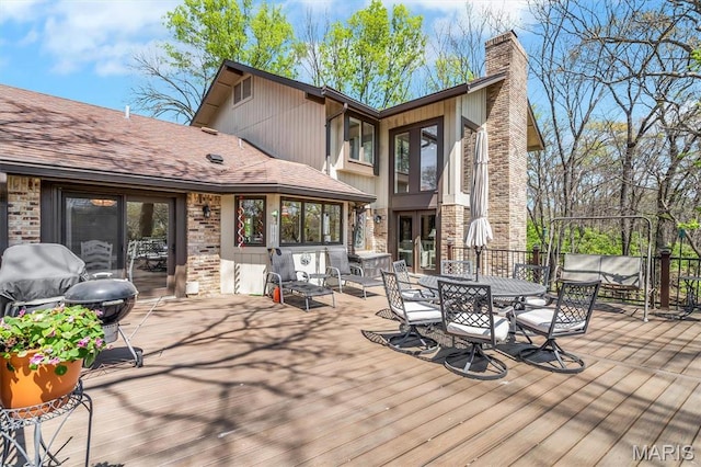 rear view of property featuring a wooden deck, a chimney, and french doors