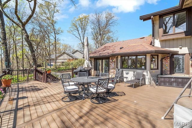 wooden terrace featuring outdoor dining space