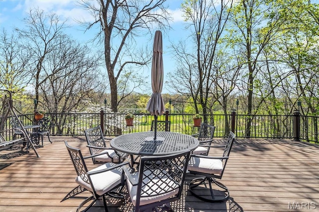 wooden terrace featuring outdoor dining space