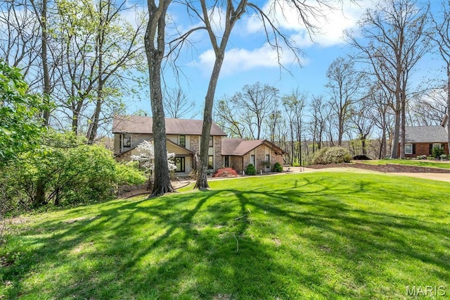 view of front of property with a front lawn and stone siding