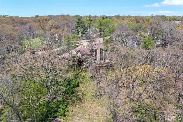 view from above of property with a heavily wooded area