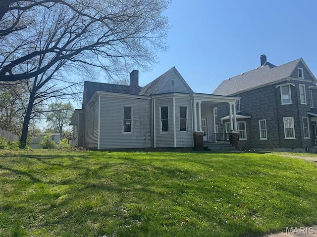 129 N Pennsylvania Ave, Belleville, IL 62220 - view of front of house featuring a chimney and a front lawn