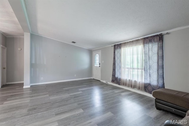 1340 Denmark Rd, Union, MO 63084 - unfurnished living room with ornamental molding, wood finished floors, baseboards, and a textured ceiling