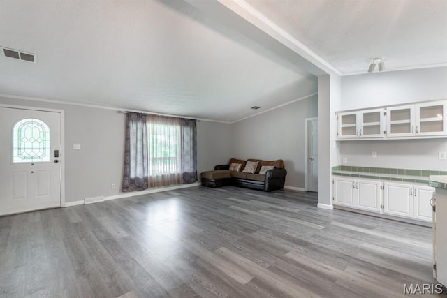 1340 Denmark Rd, Union, MO 63084 - living area featuring vaulted ceiling, crown molding, light wood-type flooring, and baseboards