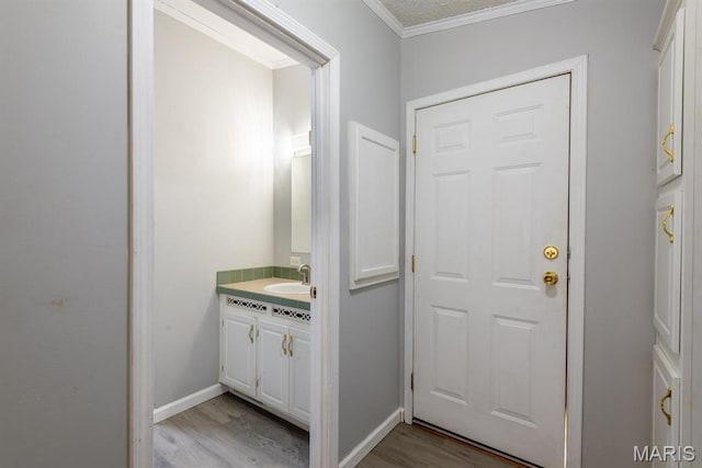 1340 Denmark Rd, Union, MO 63084 - bathroom featuring wood finished floors, vanity, crown molding, and baseboards