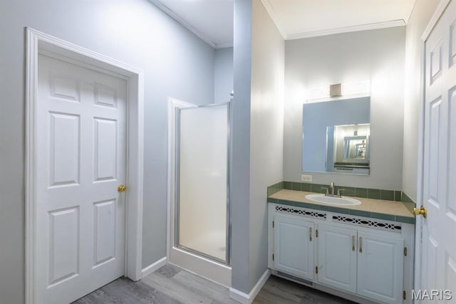 1340 Denmark Rd, Union, MO 63084 - bathroom with wood finished floors, a stall shower, ornamental molding, vanity, and baseboards