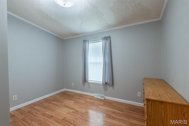1340 Denmark Rd, Union, MO 63084 - unfurnished room with light wood-type flooring, a textured ceiling, baseboards, and crown molding