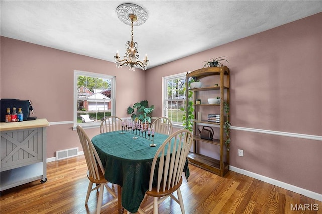 6623 Neosho St, Saint Louis, MO 63109 - dining space featuring a chandelier, baseboards, and wood finished floors
