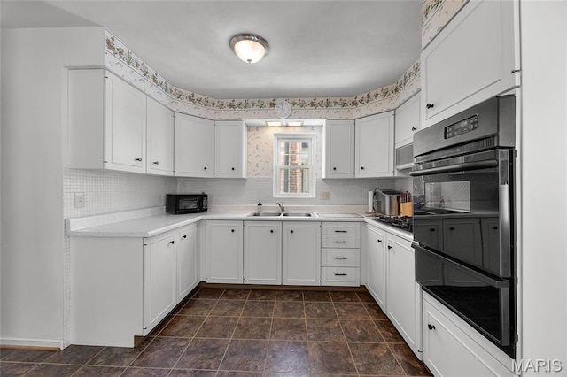 6623 Neosho St, Saint Louis, MO 63109 - kitchen with a sink, light countertops, white cabinetry, and decorative backsplash