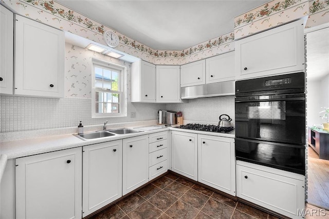 6623 Neosho St, Saint Louis, MO 63109 - kitchen featuring black oven, a sink, a warming drawer, white cabinets, and light countertops