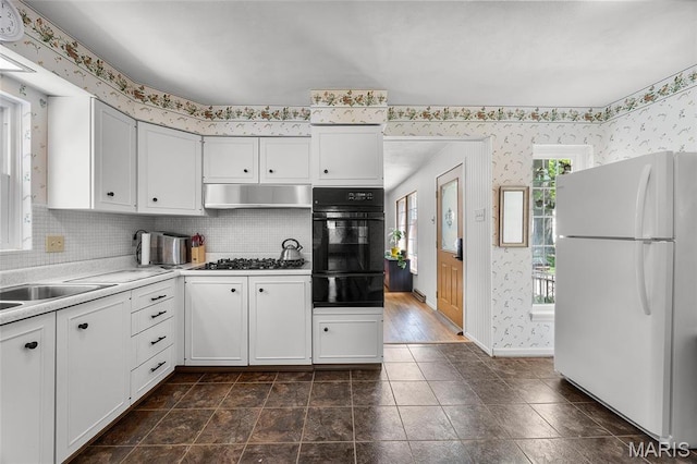 6623 Neosho St, Saint Louis, MO 63109 - kitchen with freestanding refrigerator, oven, wallpapered walls, a warming drawer, and stainless steel gas stovetop