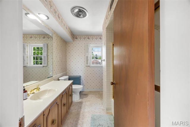 6623 Neosho St, Saint Louis, MO 63109 - bathroom with wallpapered walls, toilet, vanity, and baseboards