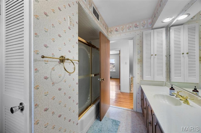 6623 Neosho St, Saint Louis, MO 63109 - bathroom with wallpapered walls, a closet, vanity, and enclosed tub / shower combo