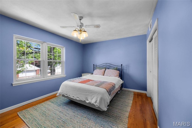 6623 Neosho St, Saint Louis, MO 63109 - bedroom featuring a closet, wood finished floors, baseboards, and a ceiling fan