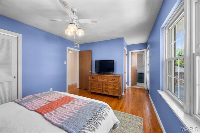 6623 Neosho St, Saint Louis, MO 63109 - bedroom with baseboards, wood finished floors, ceiling fan, and a closet