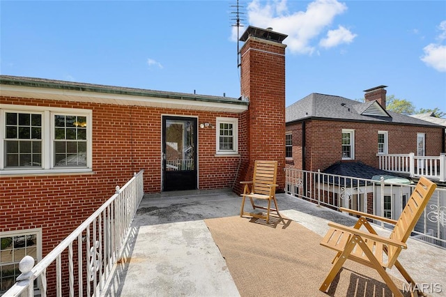 6623 Neosho St, Saint Louis, MO 63109 - rear view of house featuring a chimney and brick siding