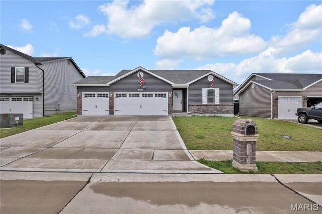 1103 Baseball Dr, Foristell, MO 63348 - view of front facade with brick siding, a front yard, driveway, a garage, and central AC