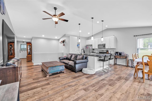 1103 Baseball Dr, Foristell, MO 63348 - living room featuring vaulted ceiling, ceiling fan, light wood-type flooring, recessed lighting, and baseboards