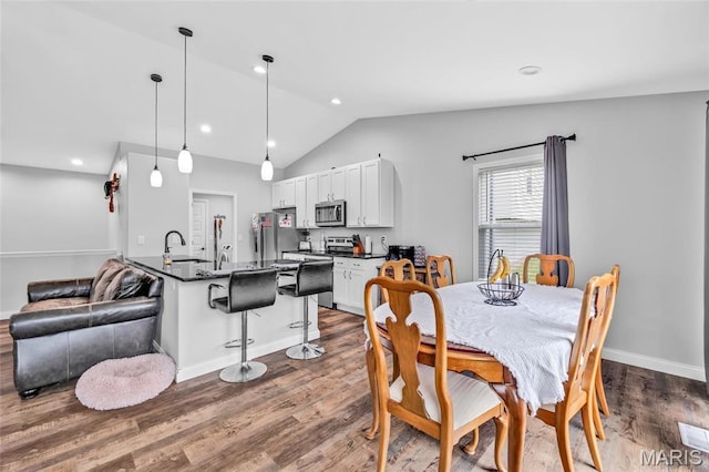 1103 Baseball Dr, Foristell, MO 63348 - dining space featuring dark wood finished floors, lofted ceiling, baseboards, and recessed lighting