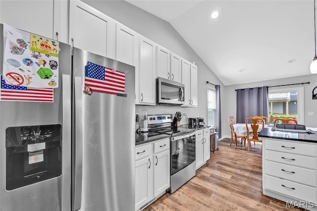 1103 Baseball Dr, Foristell, MO 63348 - kitchen with stainless steel appliances, lofted ceiling, light wood-type flooring, white cabinetry, and recessed lighting