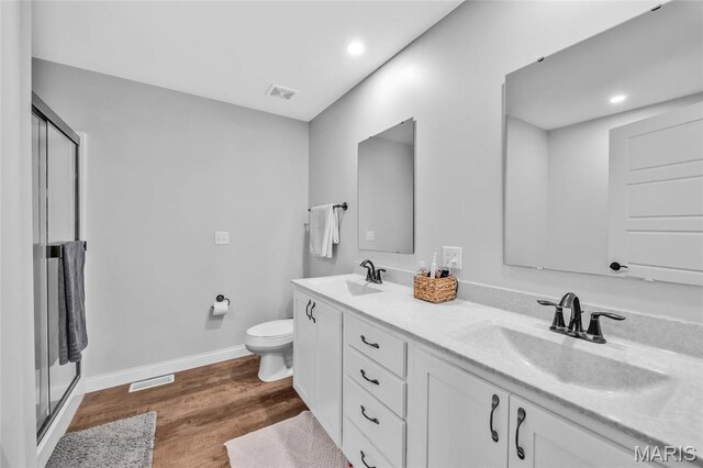 1103 Baseball Dr, Foristell, MO 63348 - full bathroom with wood finished floors, a stall shower, double vanity, toilet, and baseboards