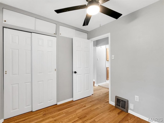 3100 Edgemont Ct, Saint Ann, MO 63074 - unfurnished bedroom with light wood finished floors, baseboards, a ceiling fan, and a closet