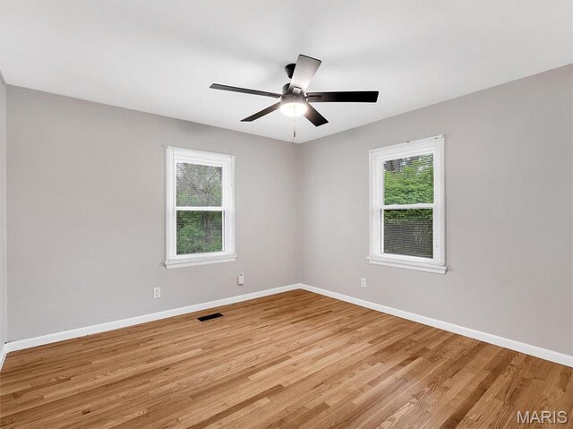 3100 Edgemont Ct, Saint Ann, MO 63074 - unfurnished room with healthy amount of natural light, light wood-style floors, baseboards, and ceiling fan