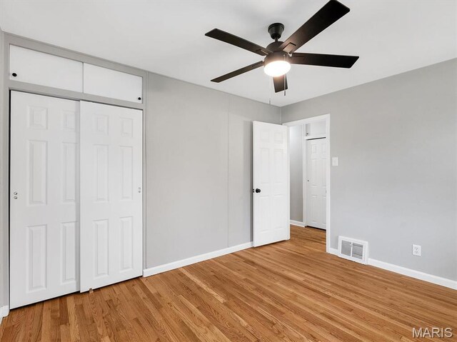 3100 Edgemont Ct, Saint Ann, MO 63074 - unfurnished bedroom with baseboards, light wood-style flooring, ceiling fan, and a closet