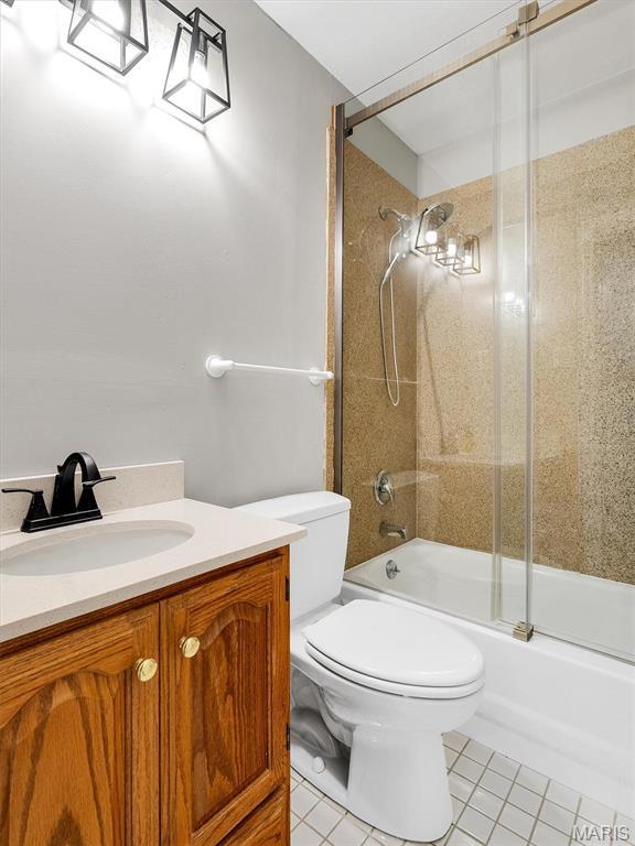 3100 Edgemont Ct, Saint Ann, MO 63074 - full bathroom featuring vanity, toilet, shower / bath combination with glass door, and tile patterned flooring