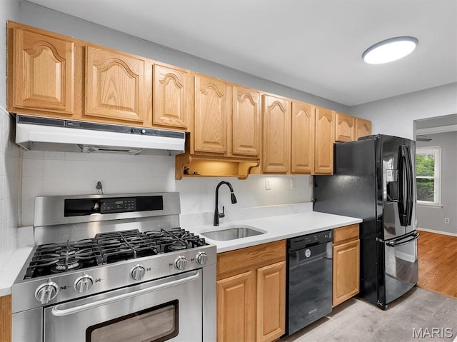 3100 Edgemont Ct, Saint Ann, MO 63074 - kitchen featuring black appliances, under cabinet range hood, a sink, light countertops, and backsplash