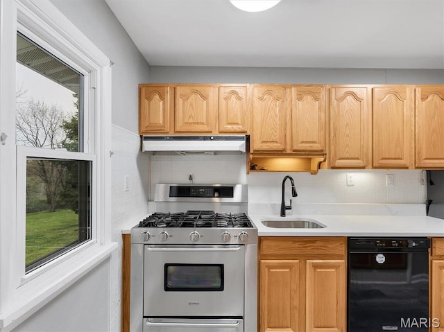 3100 Edgemont Ct, Saint Ann, MO 63074 - kitchen with stainless steel range with gas stovetop, under cabinet range hood, a sink, black dishwasher, and decorative backsplash