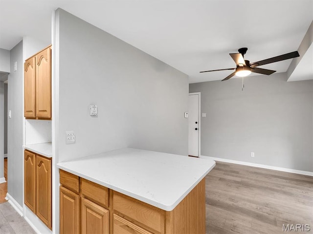 3100 Edgemont Ct, Saint Ann, MO 63074 - kitchen featuring ceiling fan, light wood finished floors, baseboards, and light countertops