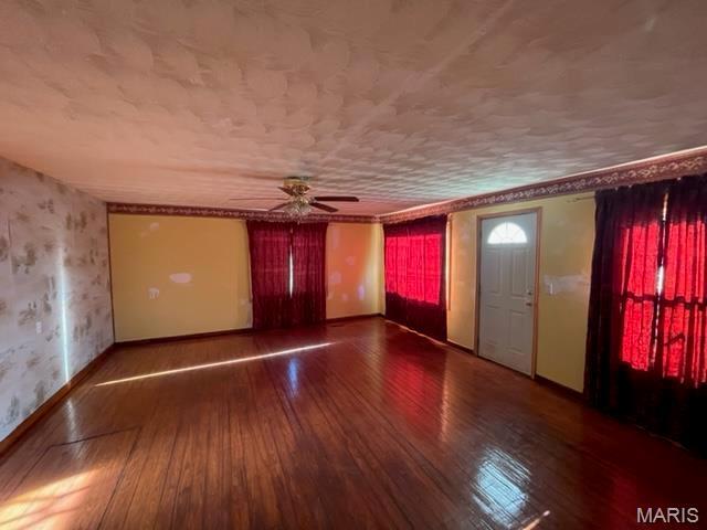 515 S Main St, Fredericktown, MO 63645 - spare room featuring wallpapered walls, hardwood / wood-style flooring, ceiling fan, and baseboards