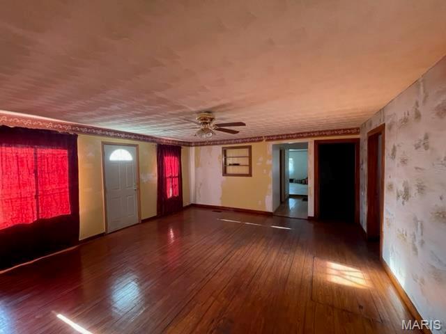 515 S Main St, Fredericktown, MO 63645 - spare room featuring hardwood / wood-style floors, ceiling fan, wallpapered walls, and baseboards