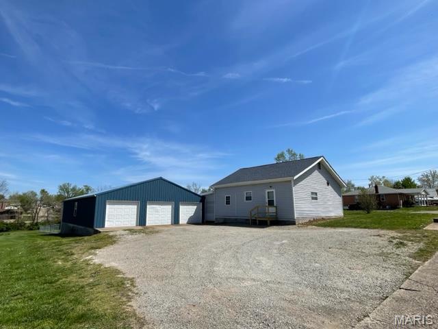 515 S Main St, Fredericktown, MO 63645 - view of front facade featuring a garage, an outbuilding, and a front lawn