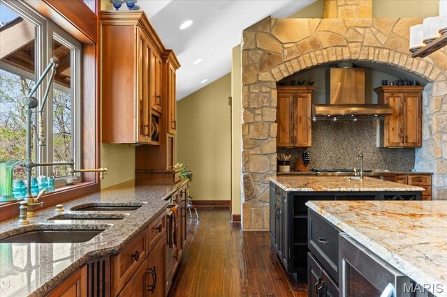 16480 Walnut Rail Rd, Chesterfield, MO 63005 - kitchen featuring custom exhaust hood, brown cabinets, dark wood-style floors, light stone counters, and recessed lighting
